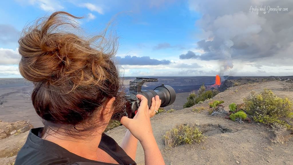 Woman photographing erupting Kīlauea with camera