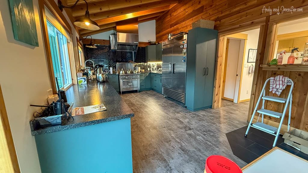 Rustic kitchen with stainless appliances and wood walls