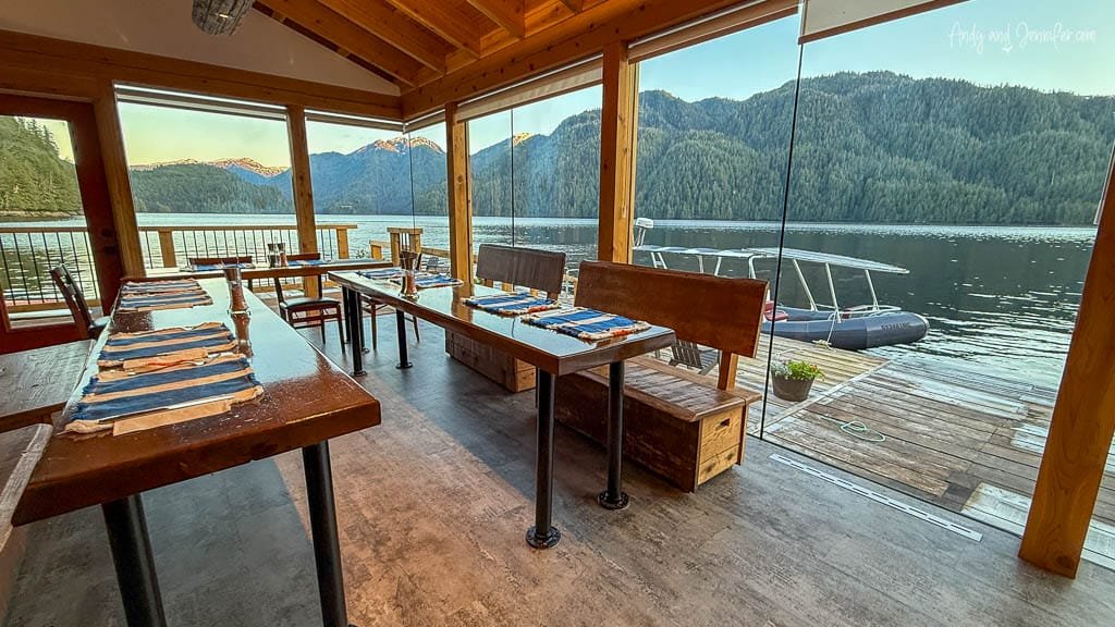 Dining area with lake views through glass walls