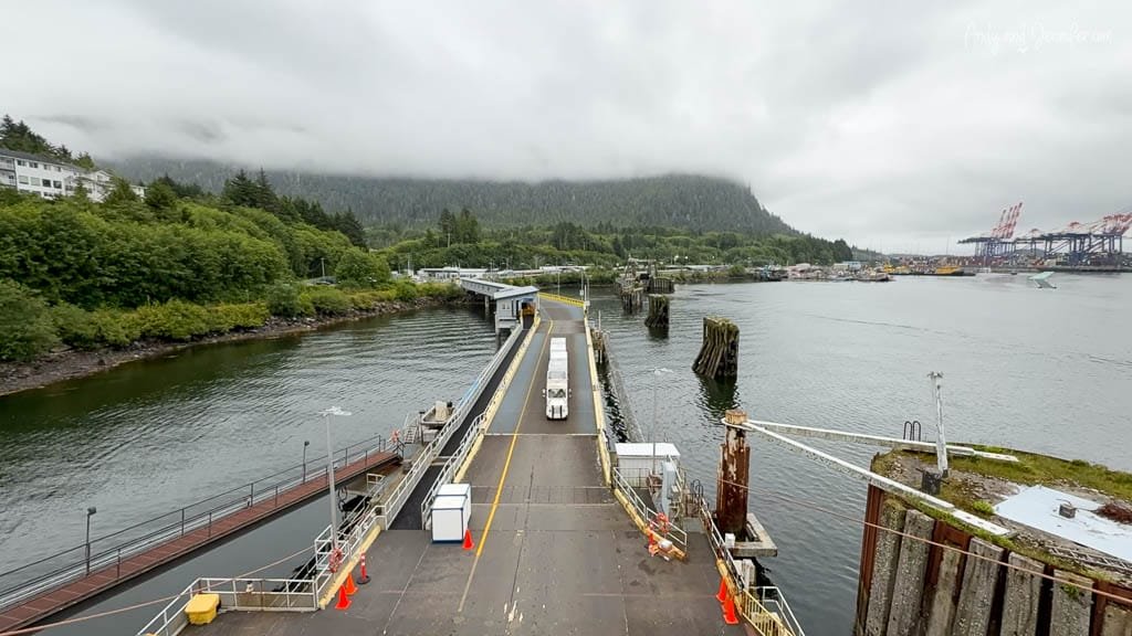 Cloudy ferry terminal with forested hillside