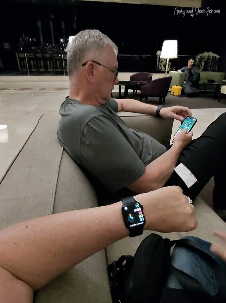 Travelers checking phones in hotel lobby before early Antarctica embarkation from Buenos Aires