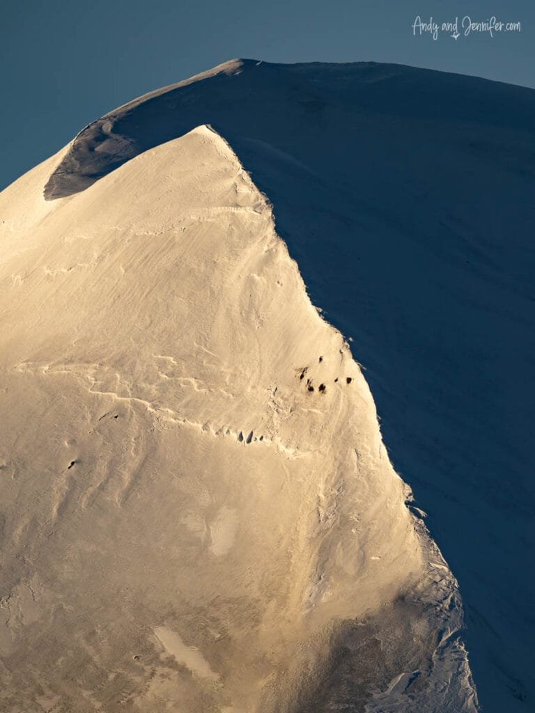 Snow-covered mountain ridge with strong light and shadow contrast in Antarctica