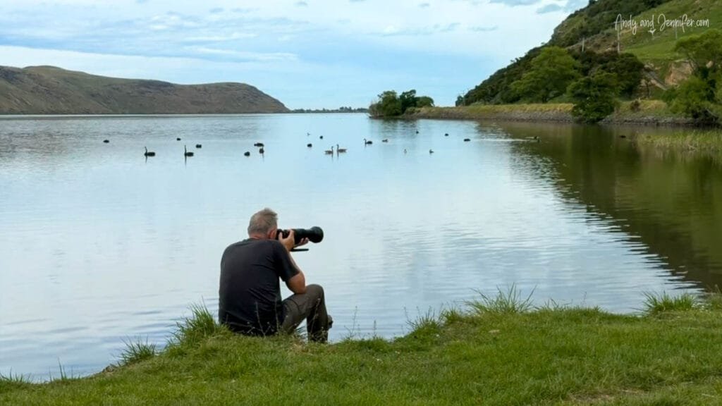 Photographer capturing birdlife at Caton’s Bay on the South Island, New Zealand