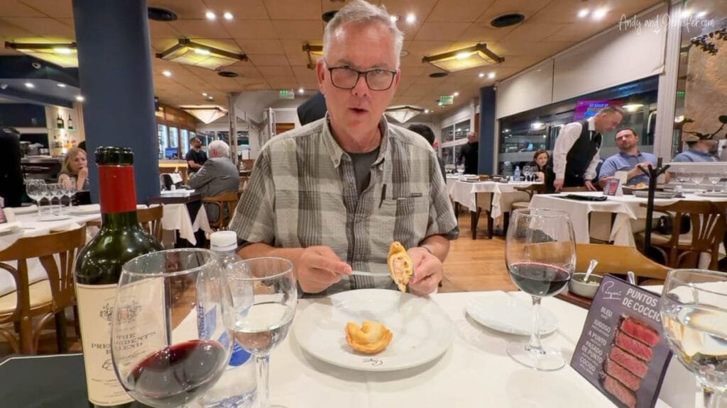 Man enjoying empanada at restaurant in Buenos Aires, Argentina