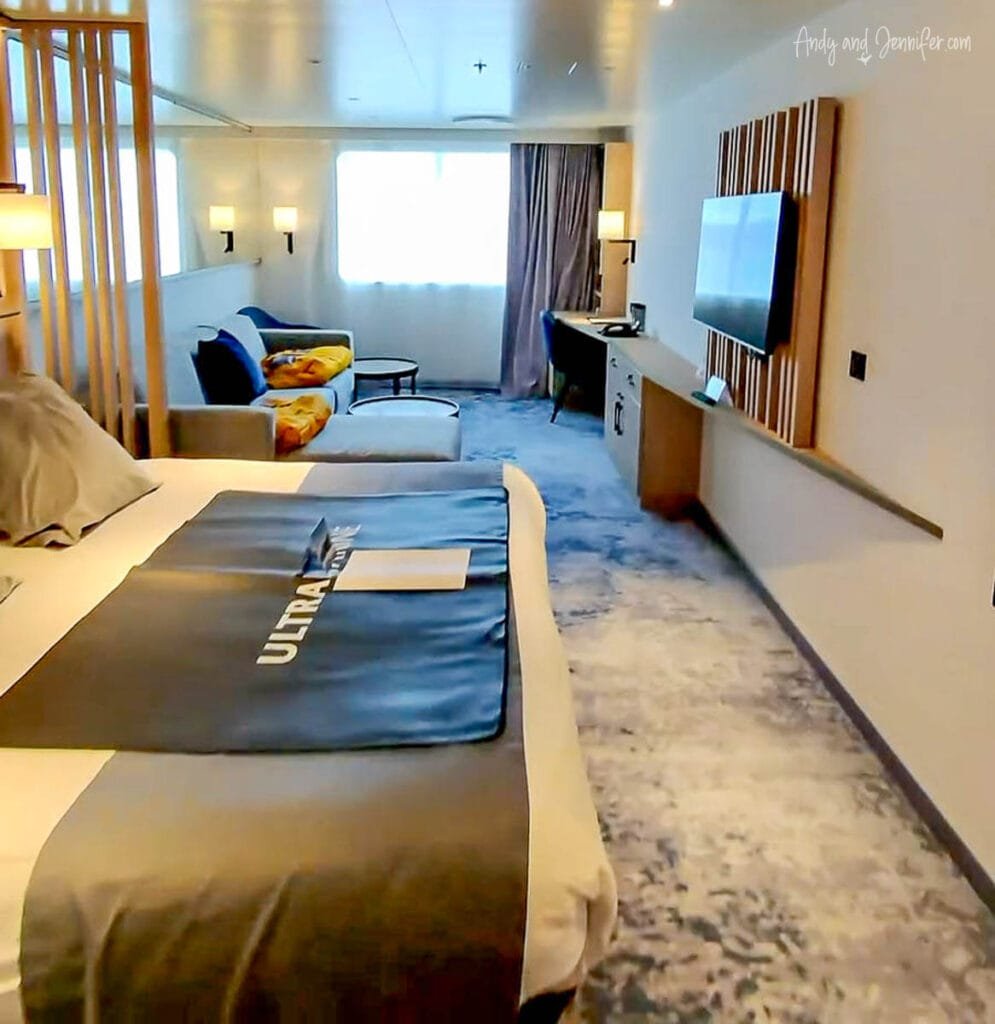Spacious cabin with bed and seating area on Quark Ultramarine Antarctica expedition ship