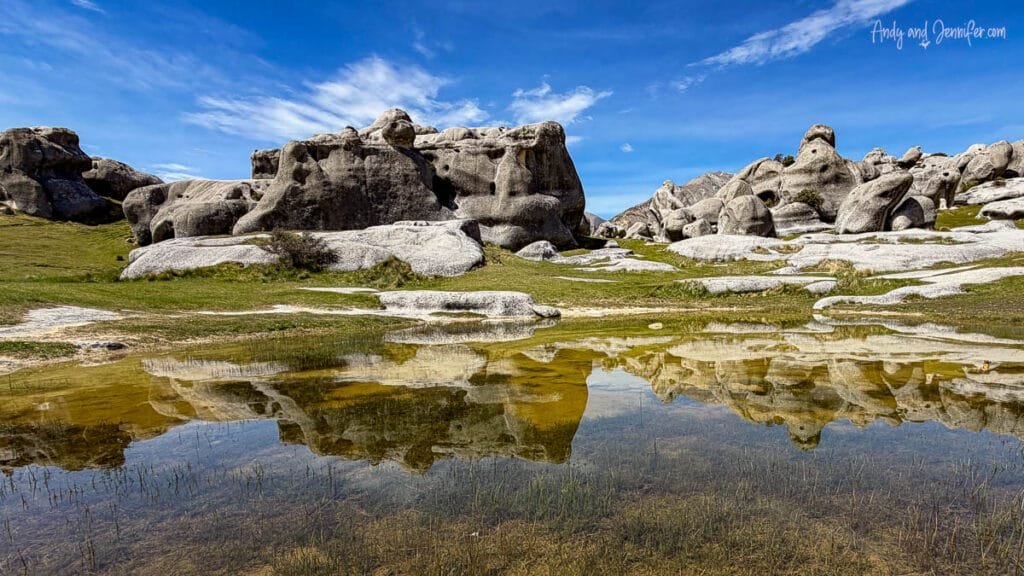 Rock formations reflected in a small pool at Castle Hill Rocks, South Island, New Zealand