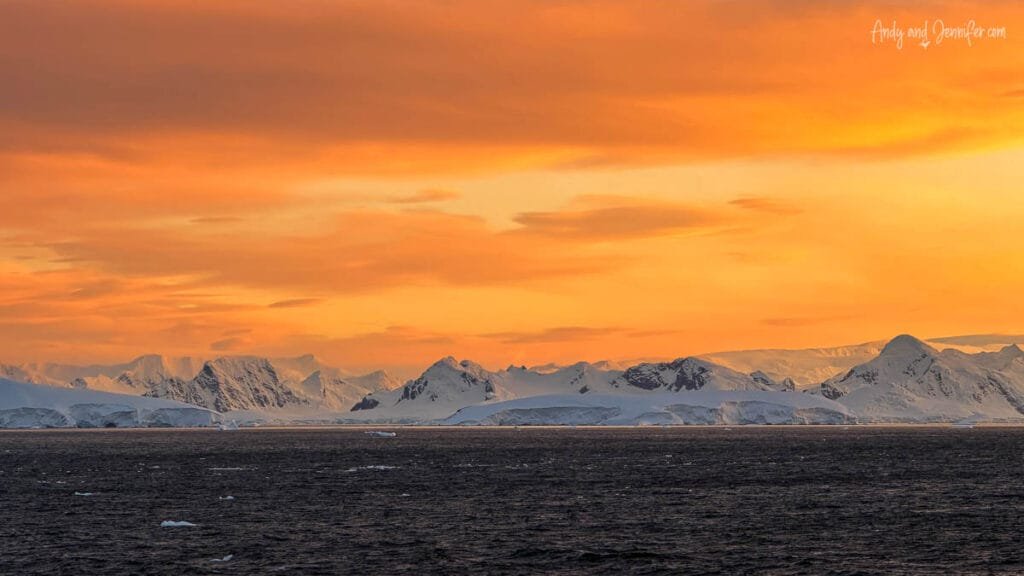 Pastel sunrise colours over Antarctic mountains and icebergs near the Lemaire Channel in Antarctica
