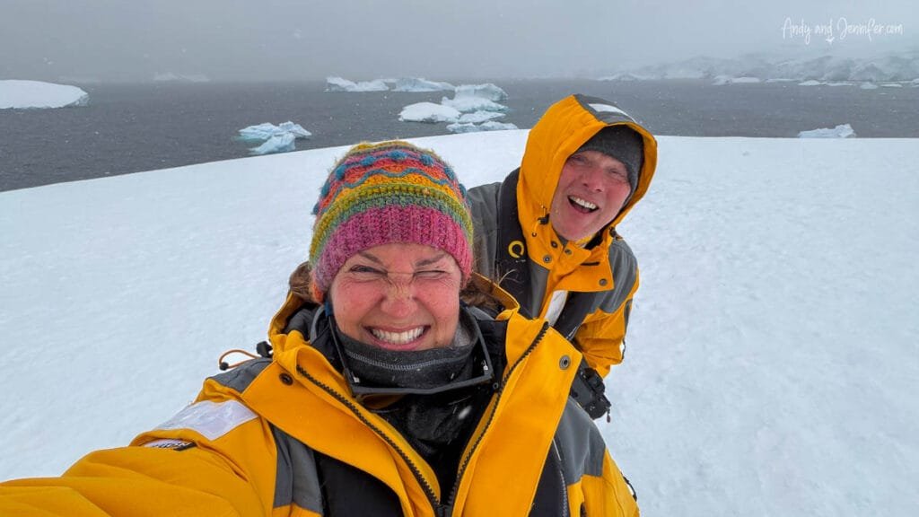 Jennifer and Andy smiling through blowing snow during their continental landing at Portal Point on the Antarctic Peninsula.
