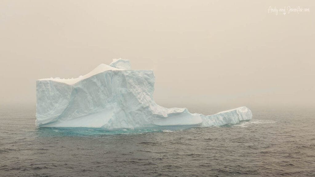 Iceberg seen from ship deck across open ocean