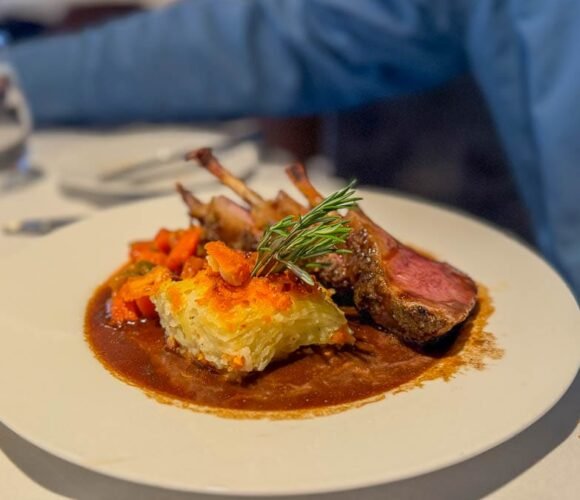 Rack of lamb with potato gratin and vegetables served in the dining room aboard the Ultramarine Antarctica expedition ship