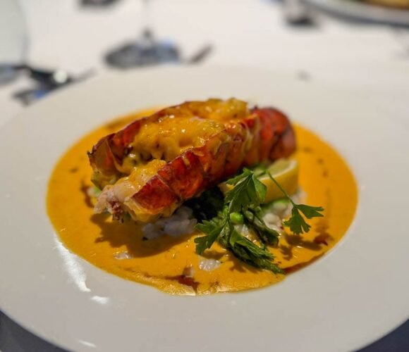 Lobster tail entrée with creamy sauce served during dinner aboard the Ultramarine expedition ship in Antarctica