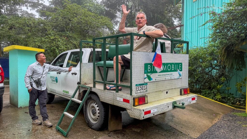 Andy riding in the Canopy Tower “Birdmobile” before a rainforest birding excursion near Pipeline Road in Panama while our guide laughs beside the vehicle outside the lodge