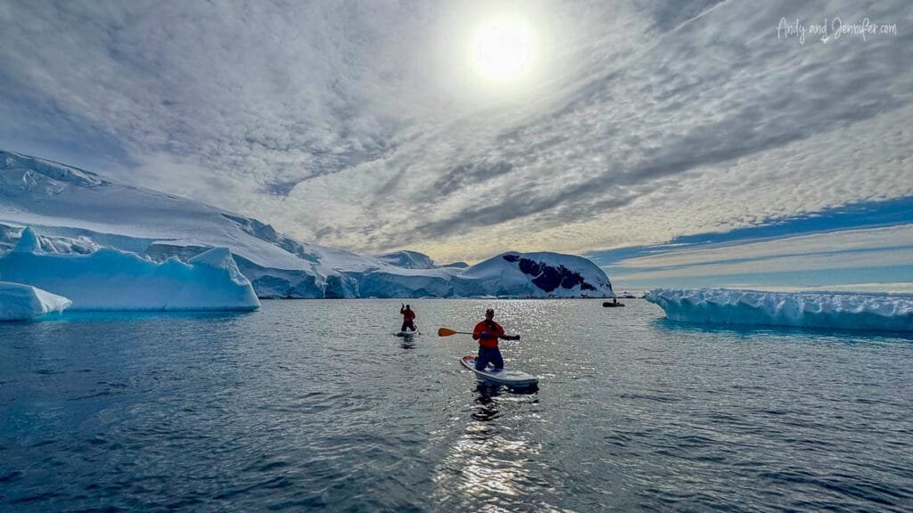 Antarctica paddleboarding near Tower Island with icebergs, glaciers, and calm polar waters under dramatic Antarctic skies