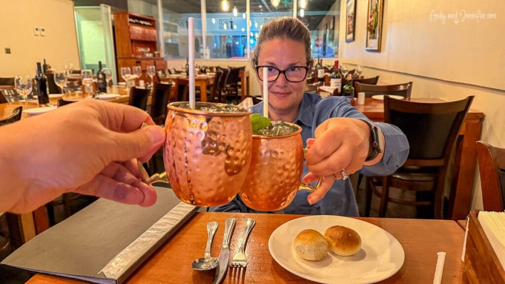 Two people toasting drinks at restaurant in Santiago, Chile