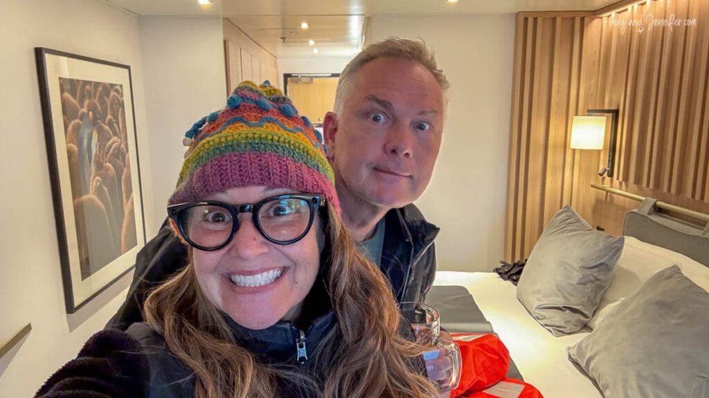 Couple smiling in cabin on Quark Ultramarine Antarctica expedition ship
