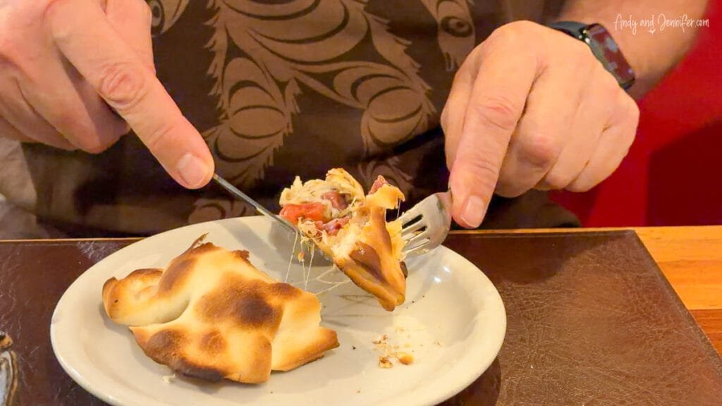 Cutting into fresh empanada at restaurant in Buenos Aires, Argentina