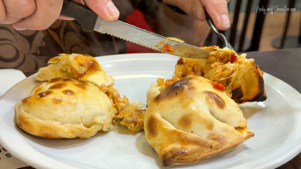 Cutting into fresh empanada at restaurant in Buenos Aires, Argentina