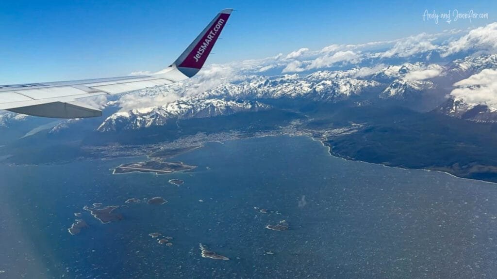 Aerial view of Ushuaia and the snow-covered Andes mountains from a JetSMART flight departing Ushuaia after an Antarctica expedition cruise