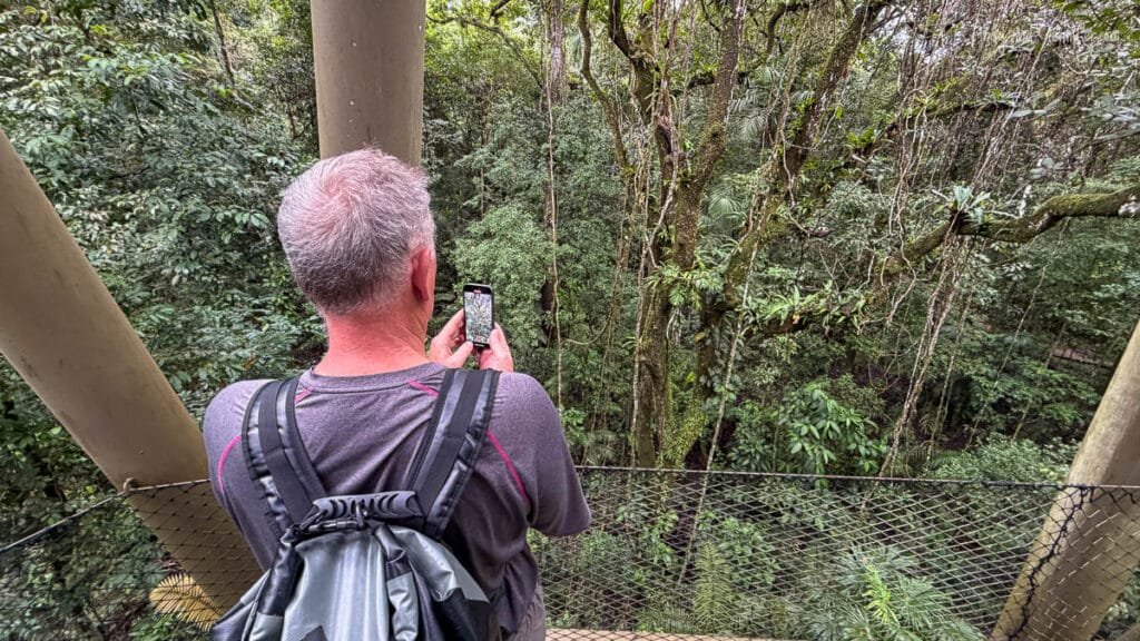Andy photographing the rainforest canopy from an observation tower in Soberanía National Park near Canopy Tower Panama.