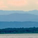 Layered mountain ridges beyond forest and water in western Panama near Bocas del Toro.
