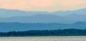 Layered mountain ridges beyond forest and water in western Panama near Bocas del Toro.