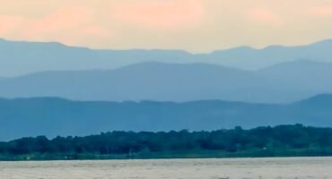 Layered mountain ridges beyond forest and water in western Panama near Bocas del Toro.