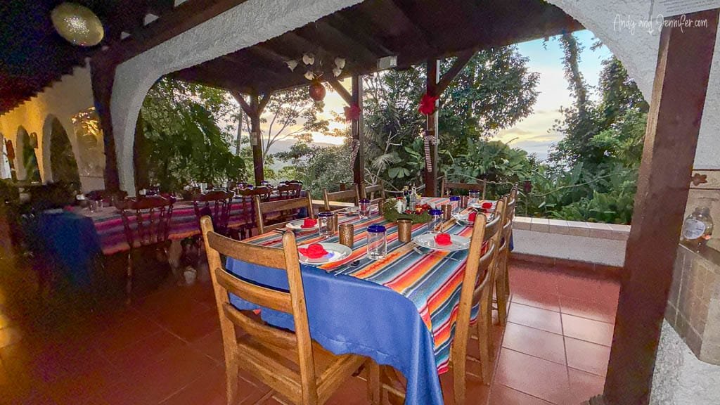 Open-air dining area set for a family-style meal overlooking the forest at Rancho Naturalista, Costa Rica.
