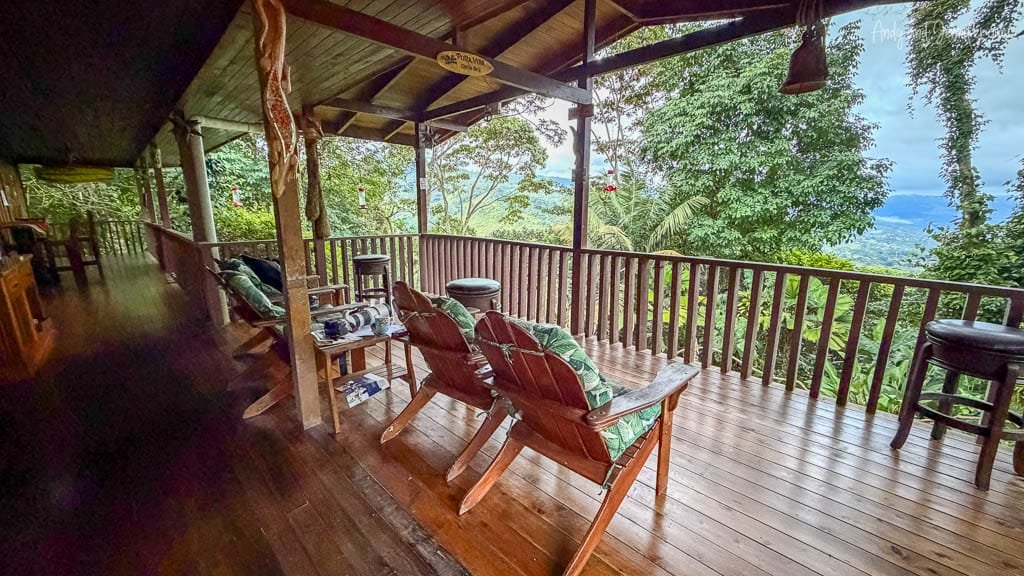 Covered birdwatching deck with seating and hummingbird feeders overlooking the forest at Rancho Naturalista, Costa Rica.