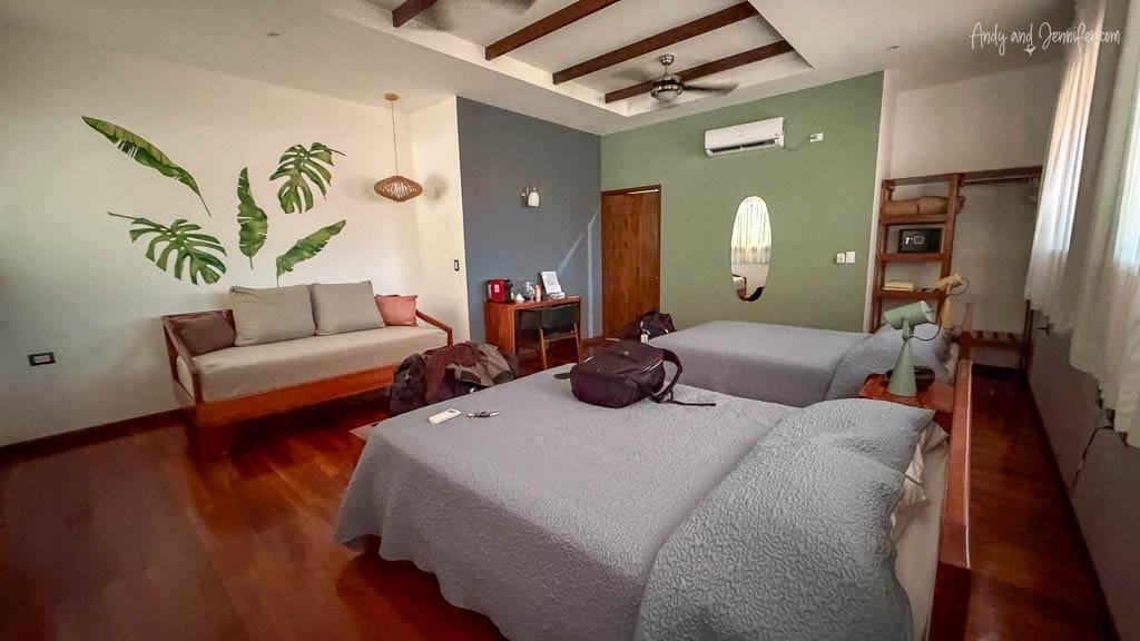 Spacious guest room with two beds and a sitting area at Selva Verde Lodge in Costa Rica.