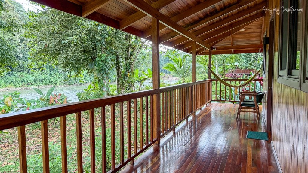 Covered wooden balcony with a hammock overlooking the river and rainforest at Selva Verde Lodge, Costa Rica.