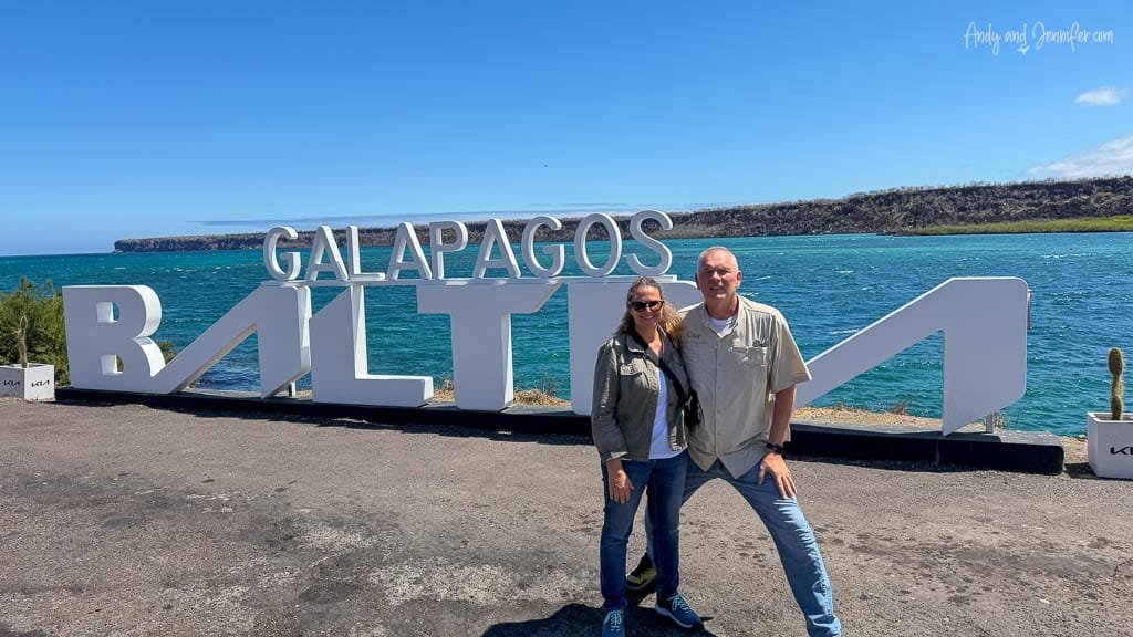 Andy and Jennifer at the Galápagos Baltra sign overlooking the water after arriving on Baltra Island.