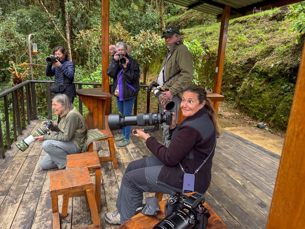Bird photographers waiting for hummingbirds at the covered viewing area at Mirador de Quetzales on Cerro de la Muerte, Costa Rica.