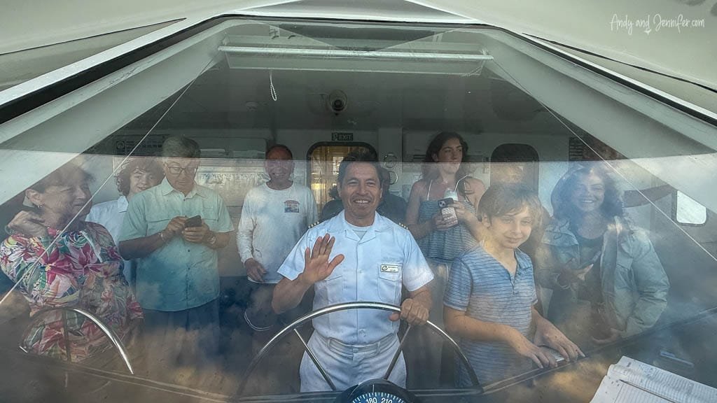Passengers gathered on the bridge of the Ecogalaxy as the ship crosses the equator in the Galápagos.