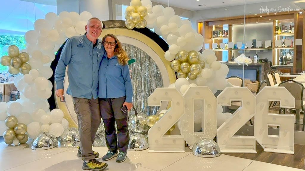 Andy and Jennifer in travel clothes beside a 2026 New Year’s Eve display at the Holiday Inn in Quito, Ecuador.