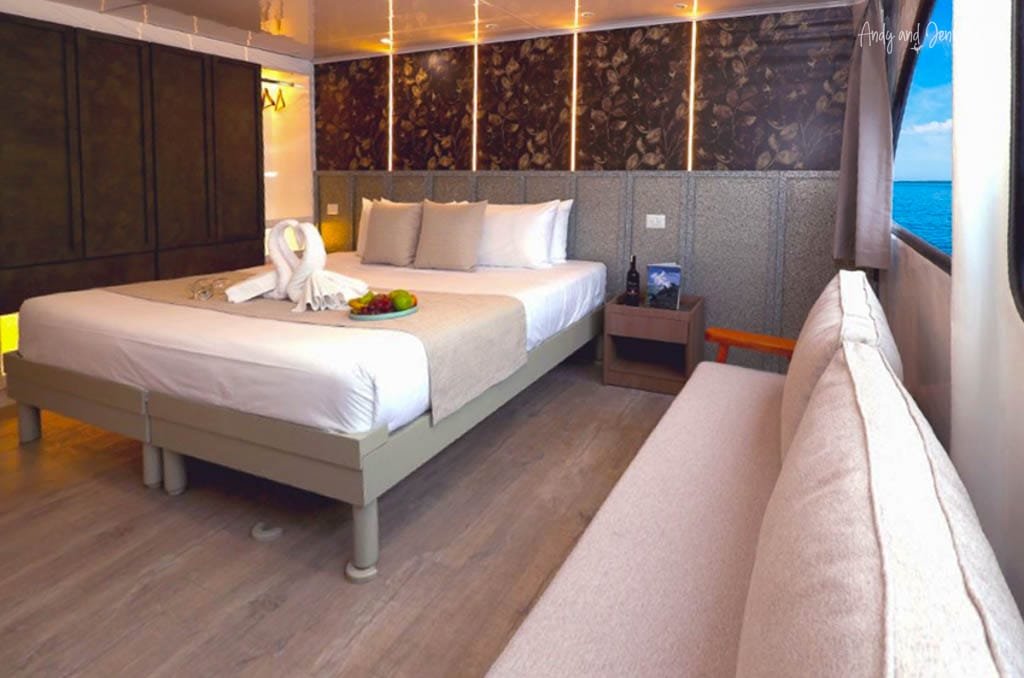 Spacious cabin aboard the Ecogalaxy catamaran with a large bed and ocean views in the Galápagos.