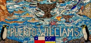Mosaic artwork featuring penguins, marine wildlife and the words “Puerto Williams” in Puerto Williams, Chile.