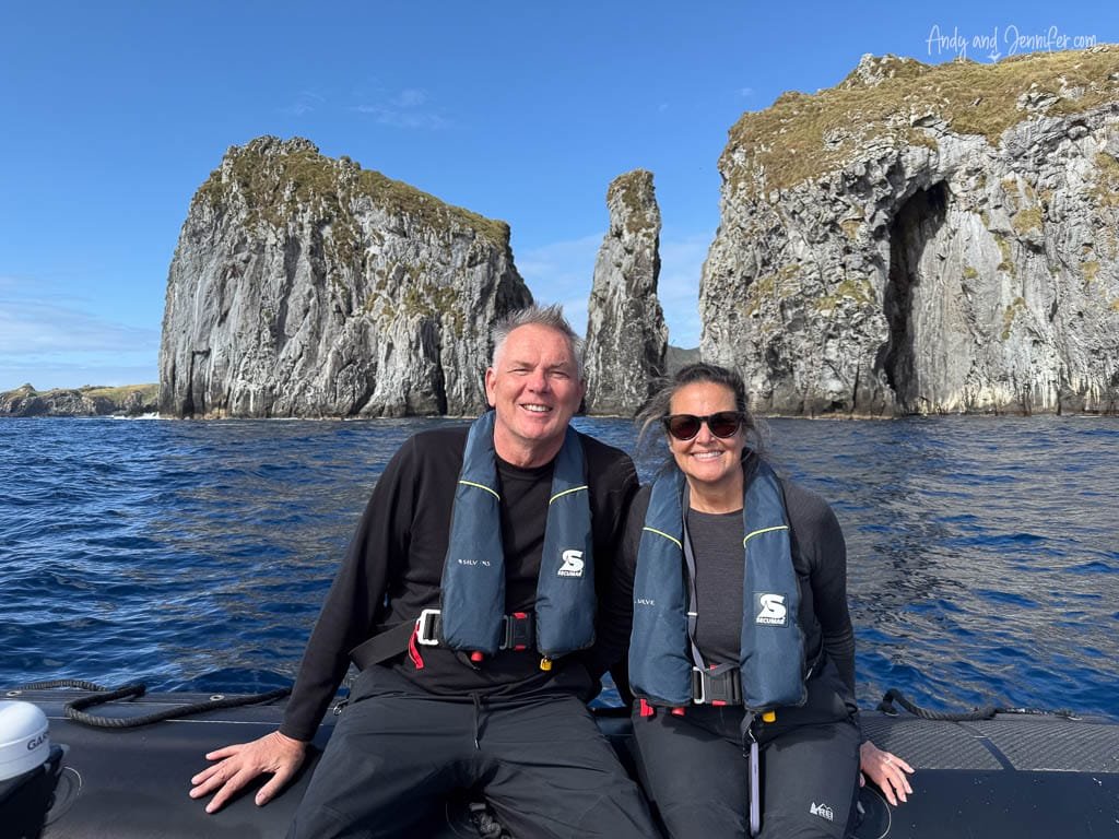 Andy and Jennifer aboard a Zodiac beneath steep seabird-covered cliffs at Nightingale Island, Tristan da Cunha.