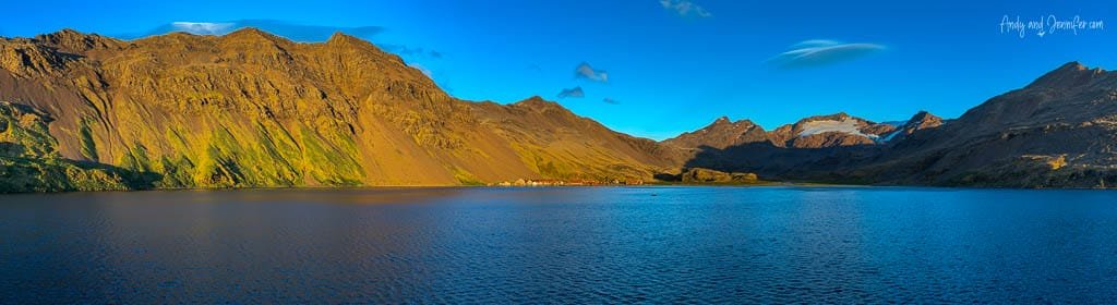 Mountain peaks glowing in evening light above the sheltered waters of Stromness, South Georgia.