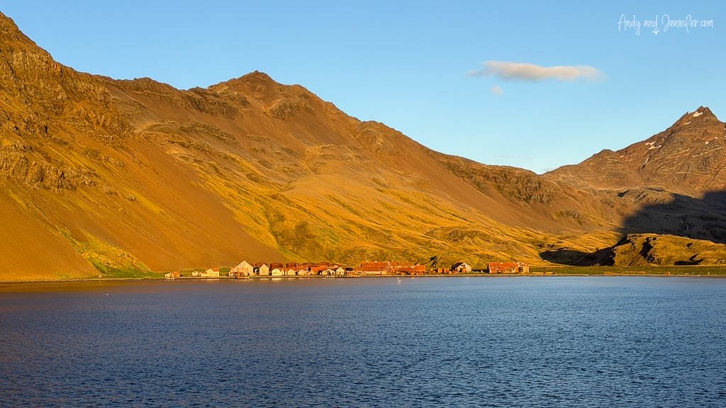 Historic whaling station at Stromness beneath sunlit mountains on South Georgia.