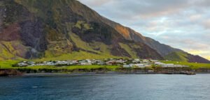 Edinburgh of the Seven Seas settlement beneath the steep volcanic slopes of Tristan da Cunha, viewed from the sea.