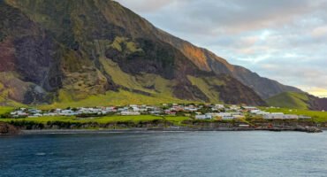 Edinburgh of the Seven Seas settlement beneath the steep volcanic slopes of Tristan da Cunha, viewed from the sea.