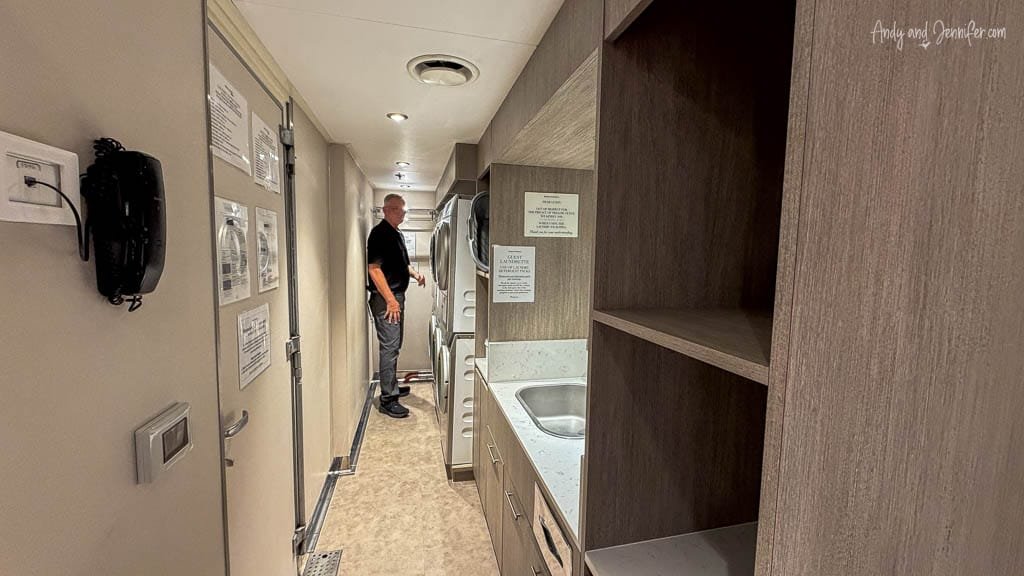 Self-service laundry room aboard Silver Wind, with washing machines, dryers, sink and storage shelves.