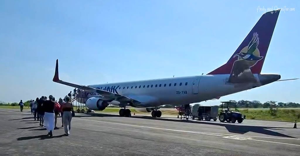 Airlink passenger plane on the tarmac as passengers board at Hoedspruit Airport, South Africa.
