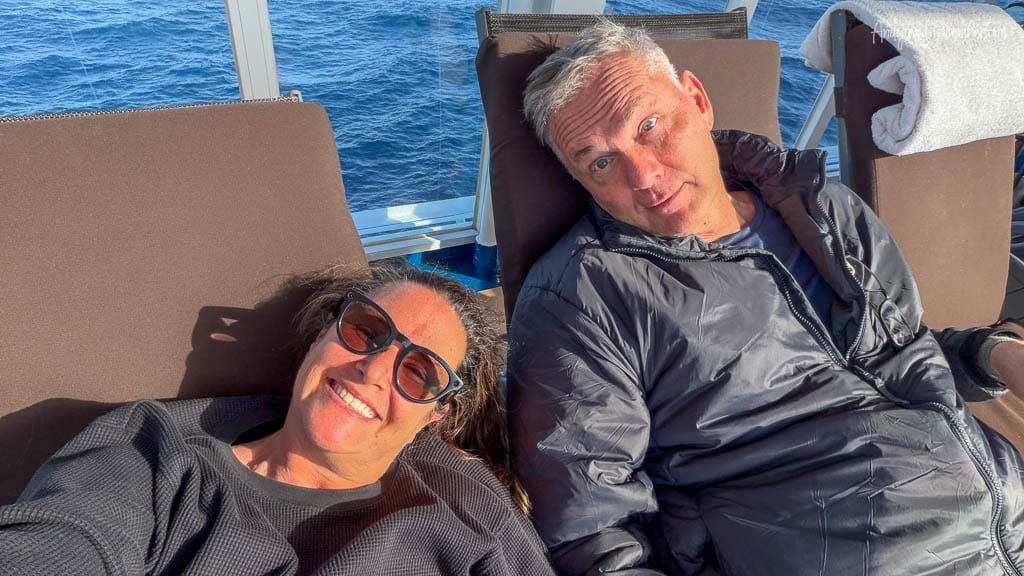 Andy and Jennifer relaxing in lounge chairs aboard Silver Wind during a sunny day at sea in the South Atlantic.