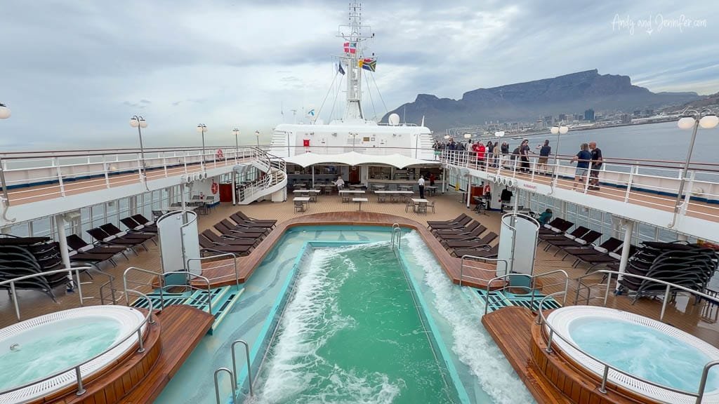 Swimming pool and hot tubs aboard Silver Wind with Table Mountain and Cape Town visible in the background.